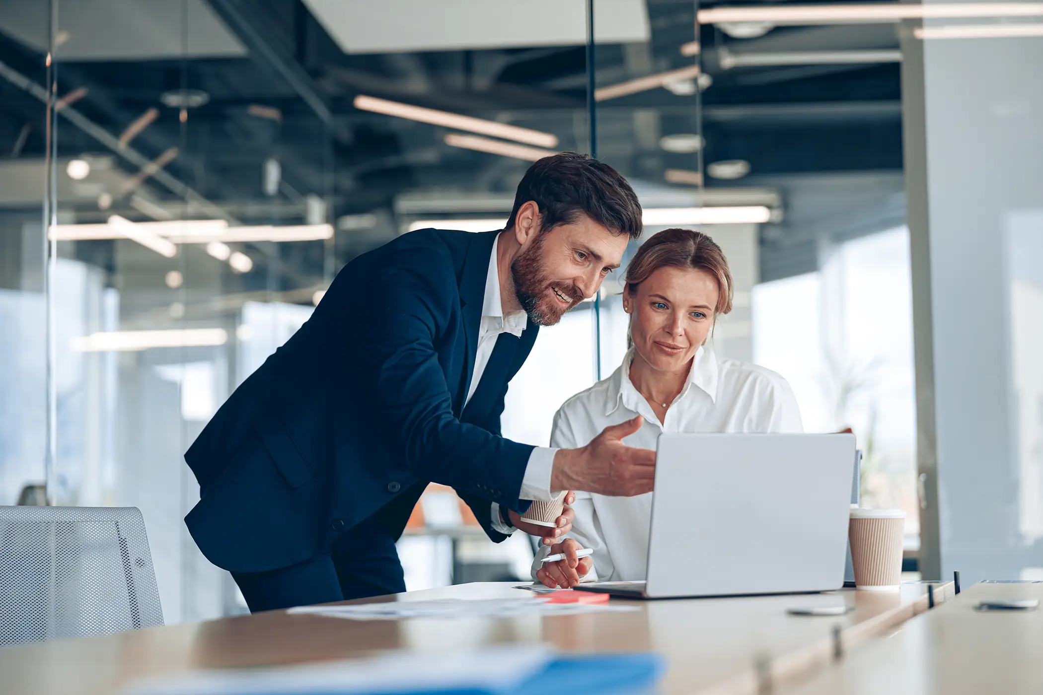 Female boss discussing online project with employee
