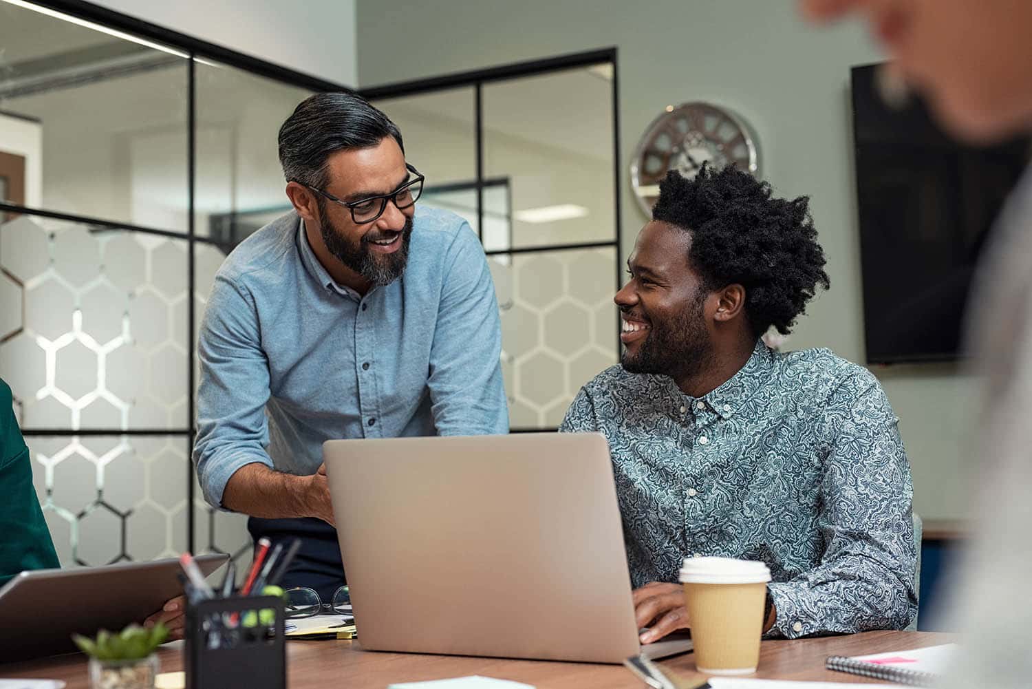 Portrait of two business partners sitting at table together and working.